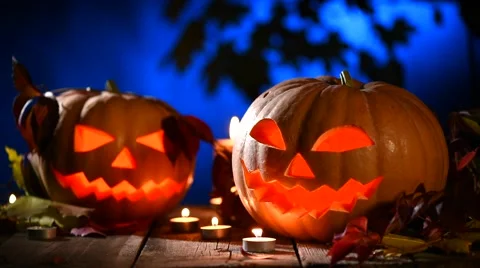 Halloween pumpkin head jack lantern with burning candles over black background. Stock Footage 59087735