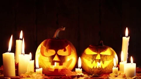 Halloween pumpkin head jack lantern with burning candles over black background Video stock 81005135