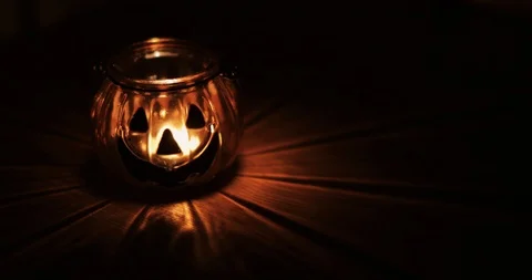 Halloween pumpkin head jack lantern with burning candles over black background Stock Footage 117191040