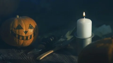 Halloween Pumpkin head lantern with burning candles on a black background on Stock Footage 80250876