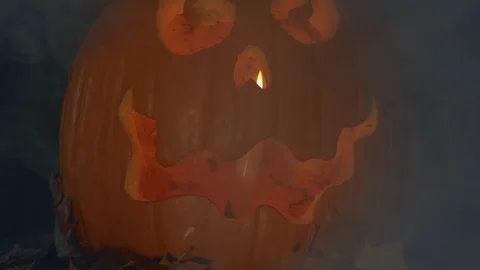 Halloween Pumpkin Jack O Lantern on black background with billowing smoke Stock Footage 119339306