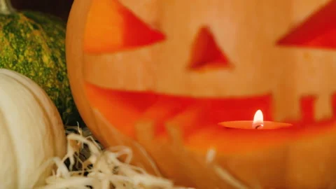 Halloween pumpkin, Jack O. Lantern Close-up pumpkin on a straw Stock Footage 162786992