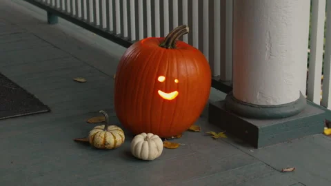 Halloween Pumpkin Jack-O'-Lantern on a Suburban Porch Stock Footage 308196949