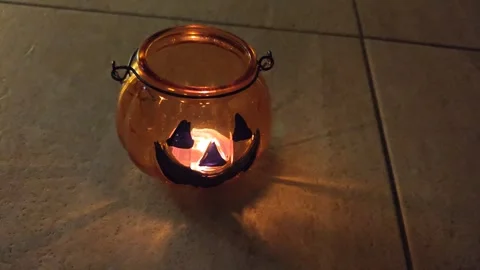 Halloween pumpkin lantern casts shadows Stock Footage 319695633