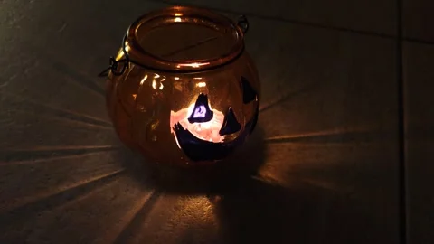 Halloween pumpkin - lantern casts shadows in the semi-darkness Stock-Footage 319695672