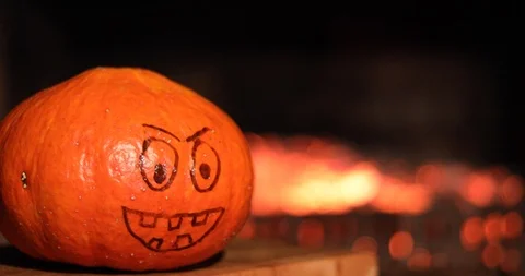 Halloween Pumpkin with a painted face on a background of fire Stock-Footage 116083243