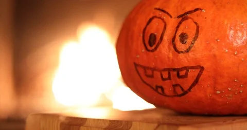 Halloween Pumpkin with a painted face on a background of fire Video stock 116083413