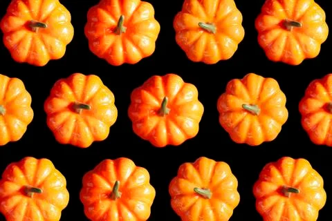 Halloween pumpkin pattern texture background on a black color background. Stock Photos