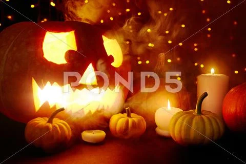 Halloween pumpkin in smoke and sparks Stock Photos