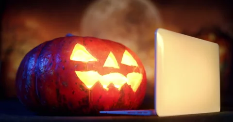 Halloween Pumpkin using laptop, watching laptop online Video stock 250349923