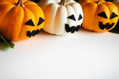 Halloween pumpkins with ghost faces on white blackground. copy space Stock Photos