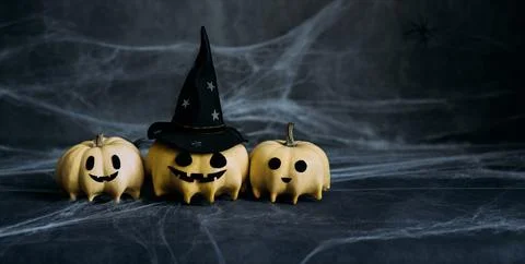 Halloween pumpkins in ghost shape on dark blue background with copy space.  Stock Photos