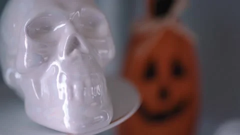 Halloween Rack focus from Jack O Lantern Decoration on Mantel to White Skull Stock Footage 141354349
