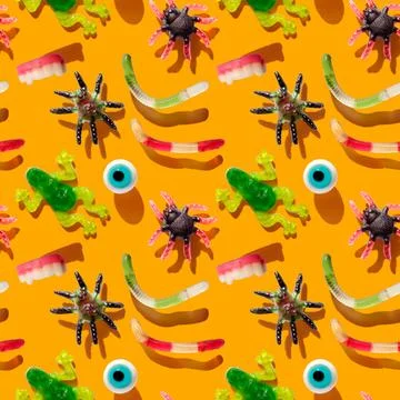 Halloween seamless pattern with gummy candy on a orange background. Jelly sweets Stock Photos