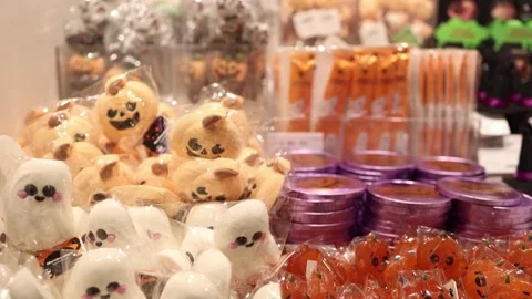 Halloween sweets display with marshmallow ghosts pumpkin treats orange lollipops Stock Footage 346305234