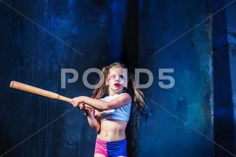 Halloween theme: Girl with baseball bat ready to hit Stock Photos