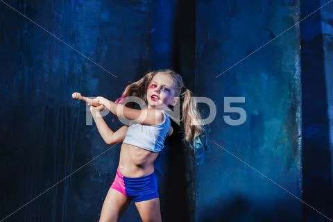 Halloween theme: Girl with baseball bat ready to hit Stock Photos