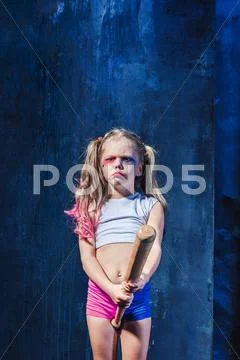 Halloween theme: Girl with baseball bat ready to hit Stock Photos