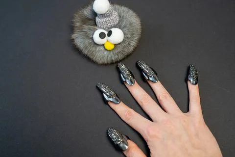 Halloween theme, witch nails, beautiful female hand with stylish manicure  Stock Photos