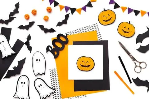 Halloween themed flat lay with ghosts bats pumpkins and decorations Stock Photos