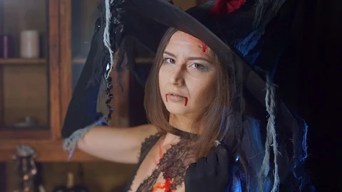 Halloween witch close-up in a hat. Upset and offended turns away 스톡 동영상 100463523