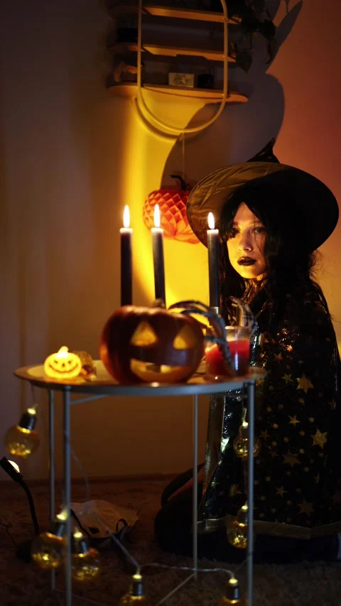 Halloween witch looks back at camera with mysterious eerie expression Stock Footage 345494086