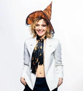 Halloween witch in magic hat. Smiling woman in halloween costume. 31 October. Stock Photos