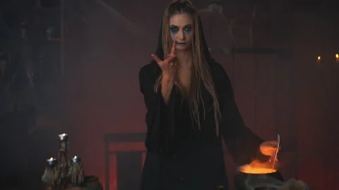 Halloween, witch use magic book and cauldron prepare poison or love potion Video stock 167835264