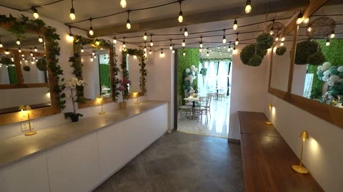 Hallway with string lights and ivy mirrors leading to an event room Stock Footage 345554025