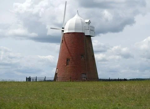 Halnaker Windmill with Red Brick Tower and White Cap under Overcast Sky Stock Photos