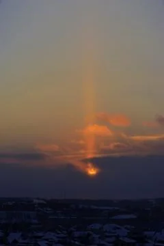 Halo in the form of a light column at sunset over the city of Kungur (Russia, Stock Photos