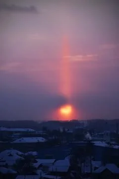 Halo in the form of a light column at sunset over the city of Kungur (Russia, Stock Photos