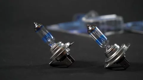 Halogen bulbs for car, panning on black background Stock Footage 161045162