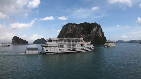 Halong bay boats drive between small hills and islands on their way. Stock Footage 178356668