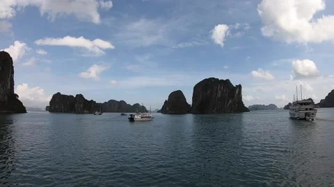 Halong bay boats drive between small hills and islands on their way. Stock Footage 178371068