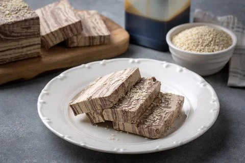 Halva dessert with sesame paste and cacao on white. Turkish name; helva Stock Photos