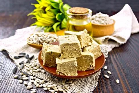 Halva in plate on dark board Stock Photos