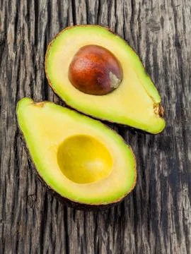 Halved avocado with core isolated on white - in macro shot. Stock Photos