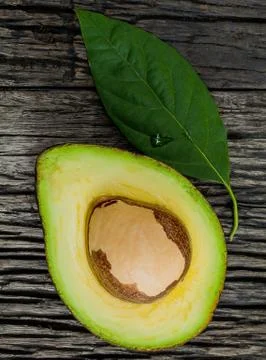 Halved avocado with core in macro shot. Stock Photos