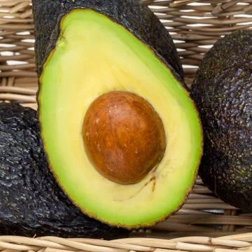 Halved avocado with core - in macro shot. Stock-Fotos
