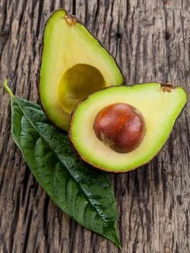 Halved avocado with core. - in macro shot. Stock Photos