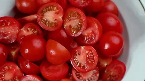 Halved cherry tomatoes rotating on slate, juicy interior, overhead view Stock Footage 326965475