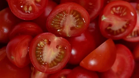 Halved Cherry Tomatoes Spinning on Dark Surface. Top-Down Seamless Motion Loop 스톡 동영상 325648072