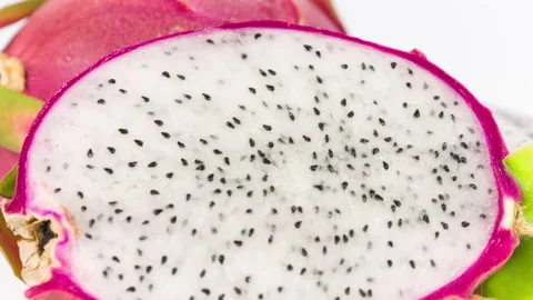 Halved fresh dragonfruit on a white background close-up rotation Stock Footage 94733856