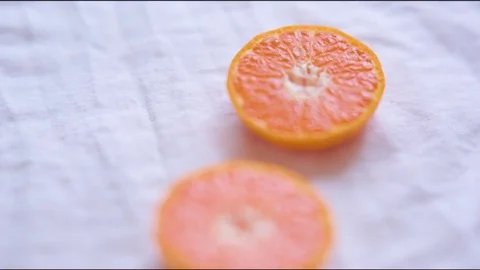 Halved grapefruit on cloth Stock Footage 76139461