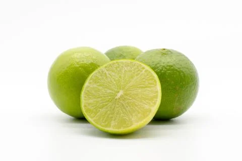 Halved  limes in front of a white background Stock Photos