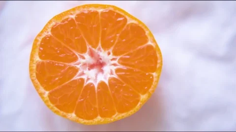 Halved orange on cloth Stock Footage 76140325