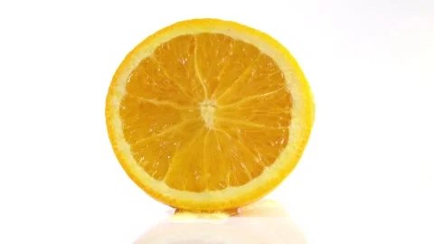Halved Orange squeezing rotating on white background isolated Stock Footage 276907072