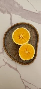 A halved orange on a white table Foto stock