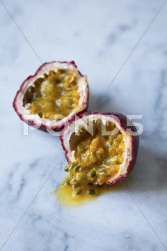 A halved passion fruit Stock Photos